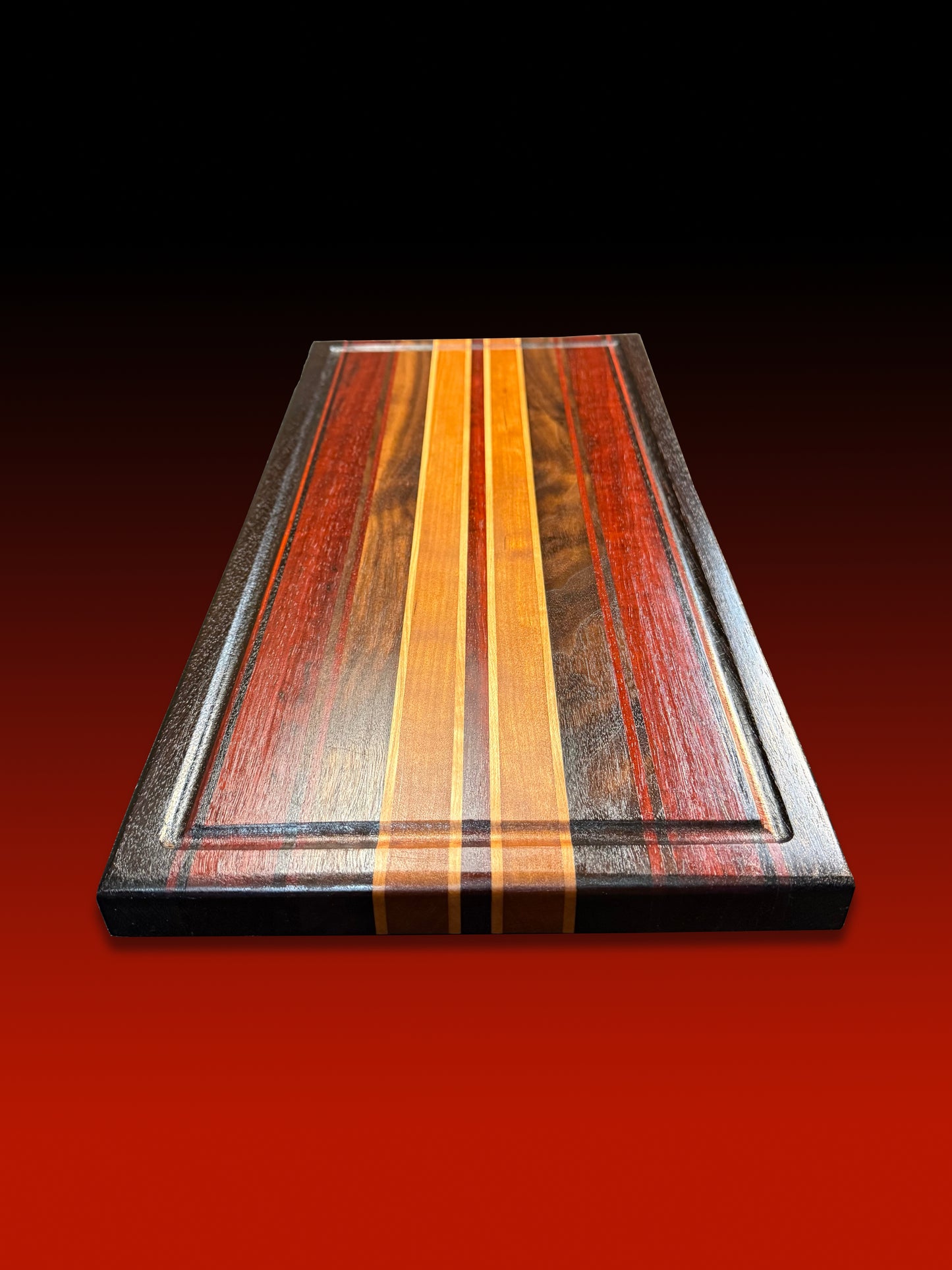 Wooden cutting board with multicolored stripes on a red background