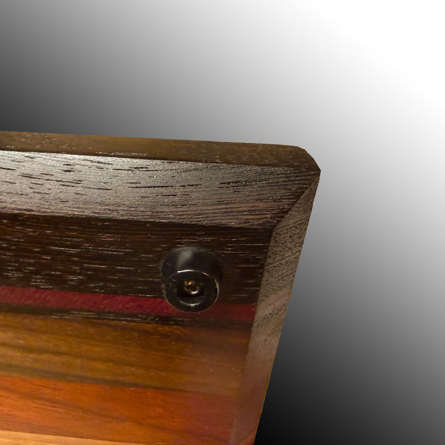 Cutting Board bottom showing beveled edge for grasping and rubber foot.